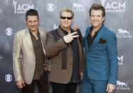 (L-R) Jay DeMarcus, Gary LeVox and Joe Don Rooney of the group Rascal Flatts arrive at the 49th Annual Academy of Country Music Awards in Las Vegas, Nevada April 6, 2014. REUTERS/Steve Marcus (UNITED STATES - Tags: ENTERTAINMENT)(ACMAWARDS-ARRIVALS)