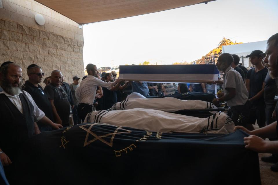 People grieve over bodies at a funeral in Israel.