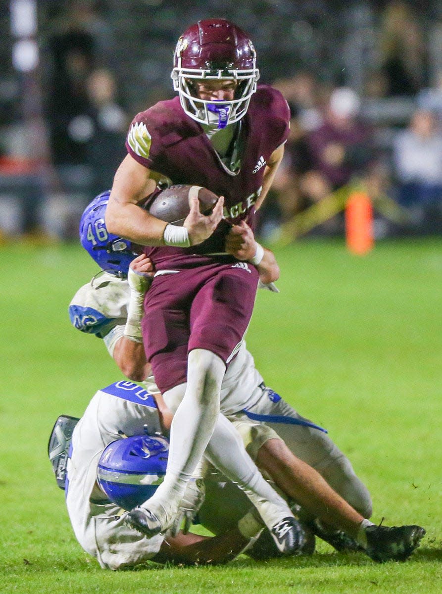 WR Maddax Fayard carries the ball as Niceville hosts Bartram Trail in the regional football semifinals at Niceville.