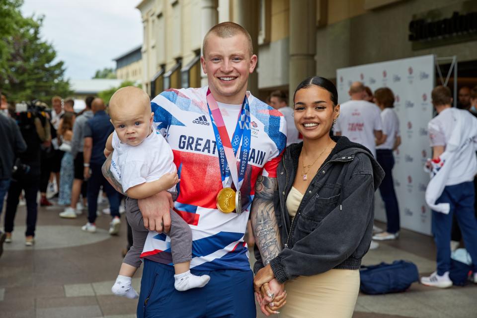 LONDON, ENGLAND - AUGUST 02: Adam Peaty poses for a photograph his wife Eirianedd Munro and their son George-Anderson Peaty during the National Lottery&#39;s event celebrating 