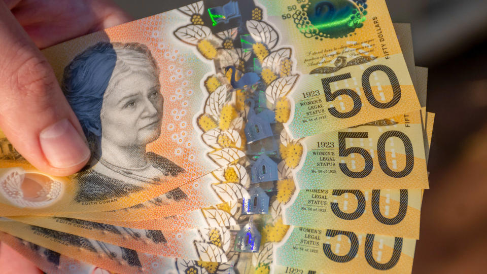 Hands holding australian dollars 50 banknotes. Finance and payment concept.