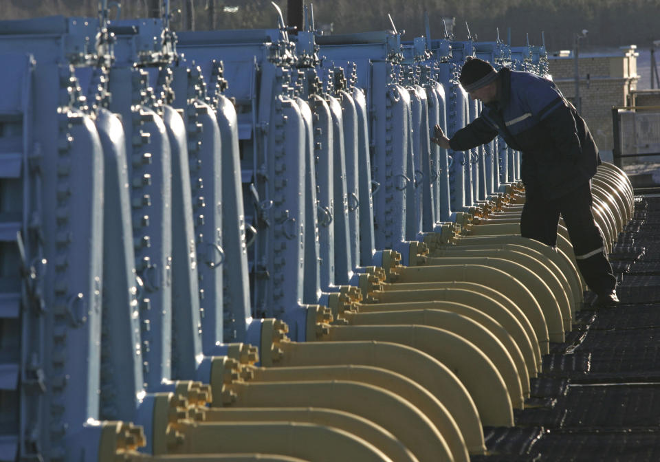 FILE - A Belarusian worker on duty at a gas compressor station of the Yamal-Europe pipeline near Nesvizh, some 130 km (81 miles) southwest of the capital Minsk, Belarus, Dec. 29, 2006. Officials in Poland and Bulgaria say Russia is suspending their countries’ natural gas deliveries starting on Wednesday. The governments of the two European countries said Tuesday April 26, 2022, that Russian energy giant Gazprom informed them it was halting gas supplies. (AP Photo/Sergei Grits, File)