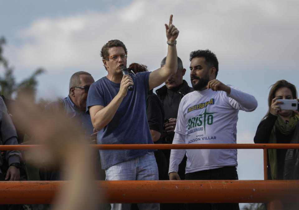 Brazil's Environment Minister, Ricardo Salles talks to supporters at the end of a caravan of motorcycle enthusiasts, organized to show support for President Jair Bolsonaro, in Sao Paulo, Brazil, Saturday, June 12, 2021. (AP Photo/Marcelo Chello)