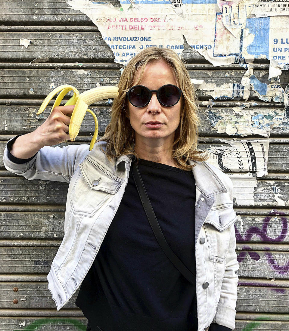 In this photo made 27 April 2019, Polish actress Magdalena Cielecka aims a banana like a gun at her head to protest the removal of an art work from the National Museum in Warsaw that features a woman eating a banana with visible pleasure, which the conservative authorities say is obscene. wld (AP Photo/Dario Salina)