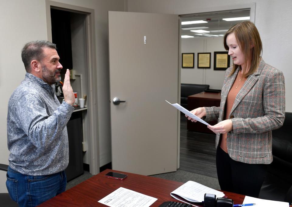 Kyle McAlister registers with Abilene City Secretary Shawna Atkinson to run for re-election for Place 5 on the city council Wednesday.