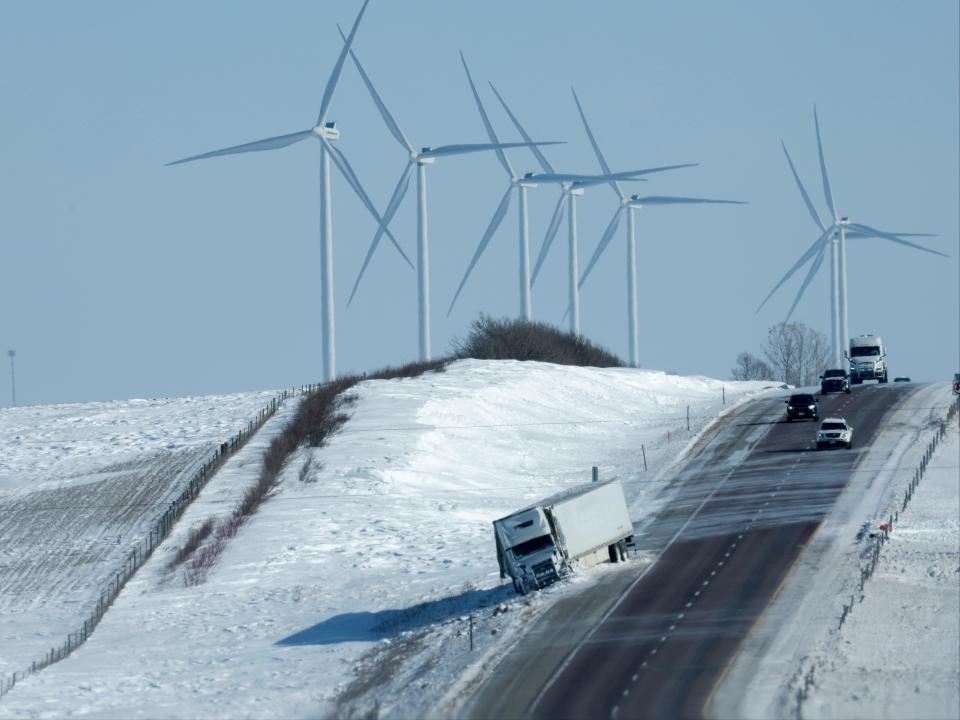 Traffic navigates past a wrecked trailer on Interstate 80 near Williamsburg, Iowa, 14 January (Chip Somodevilla/Getty Images)