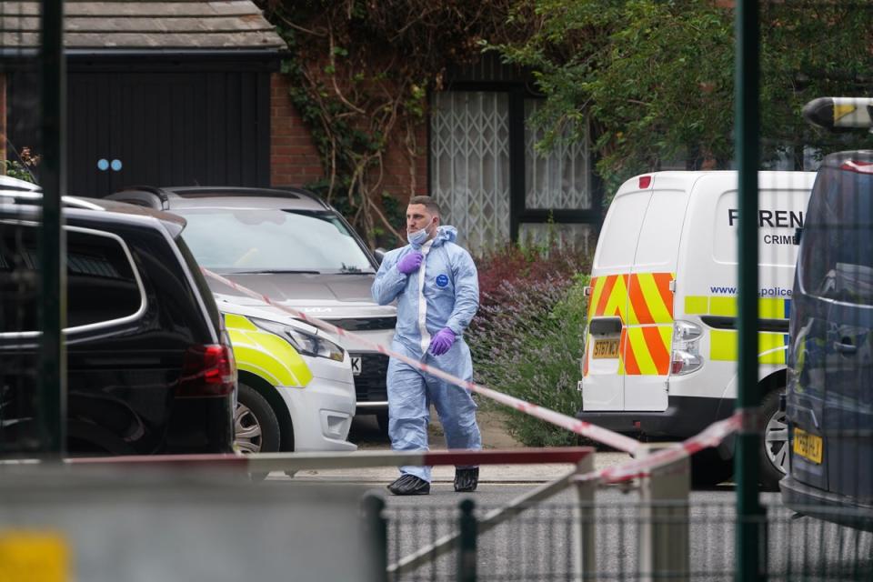 A forensic officer at an address in Shepherd’s Bush, west London, searches believed to be in connection with the human remains found in Bristol (PA)