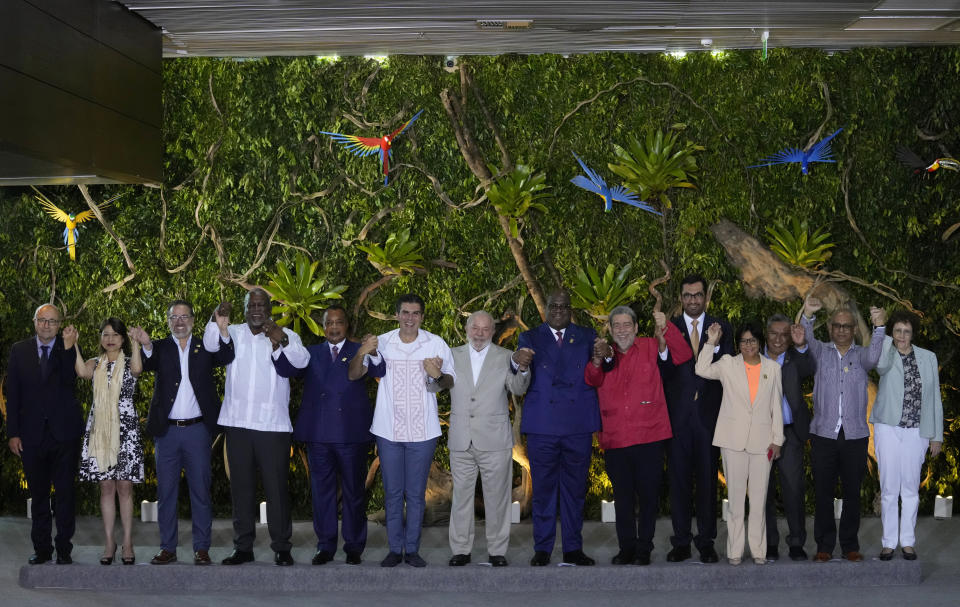 Leaders pose for a group photo during the Amazon Summit at the Hangar Convention Center in Belem, Brazil, Wednesday, Aug. 9, 2023. From left are Norway Special Envoy on Climate and Forest Hans Brattskar, Peru's Foreign Minister Ana Cecilia Gervasi, Ecuador's Foreign Minister Gustavo Manrique, Guyana's Prime Minister Mark Phillips, Republic of the Congo President Denis Sassou Nguesso, Brazil's Para state Governor Helder Barbalho, Brazil's President Luiz Inacio Lula Da Silva, Democratic Republic of Congo President Felix Tshisekedi, Saint Vincent and Grenadines Prime Minister Ralph Gonsalves, United Arab Emirates' Minister of Industry and Advanced Technology Sultan Ahmed al-Jaber, Venezuela's Vice President Delcy Rodriguez, Bolivia's Foreign Minister Rogelio Mayta, Suriname's Foreign Affairs Minister Albert Ramdin and France's Ambassador to Brazil Brigitte Collet. (AP Photo/Eraldo Peres)