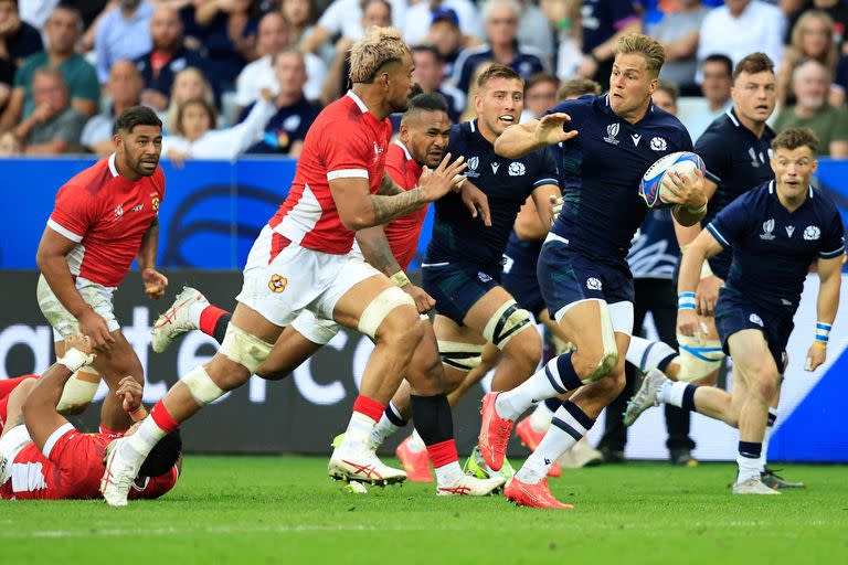 El ala izquierda de Escocia, Duhan van der Merwe (R), corre para evadir al número ocho de Tonga, Vaea Fifita (L), durante el partido del Grupo B de la Copa Mundial de Rugby Francia 2023 entre Escocia y Tonga en el Stade de Nice en Niza