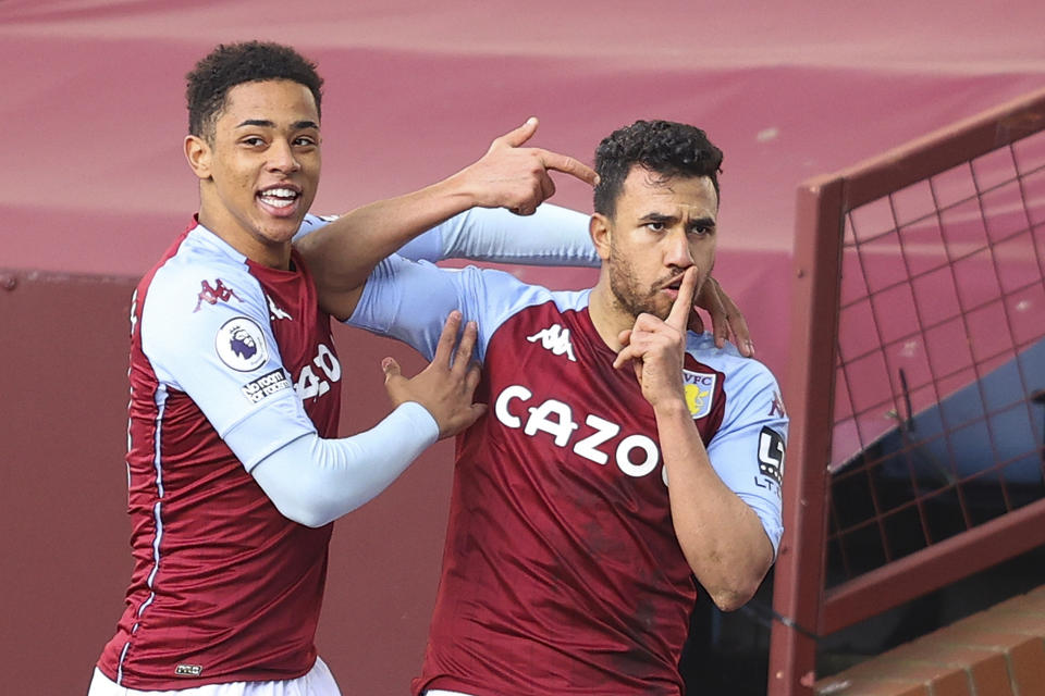 Aston Villa's Trezeguet, right, celebrates with Aston Villa's Jacob Ramsey after scoring his side's second goal during an English Premier League soccer match between Aston Villa and Fulham at Villa Park in Birmingham, England, Sunday April 4, 2021. (Richard Heathcote/Pool via AP)