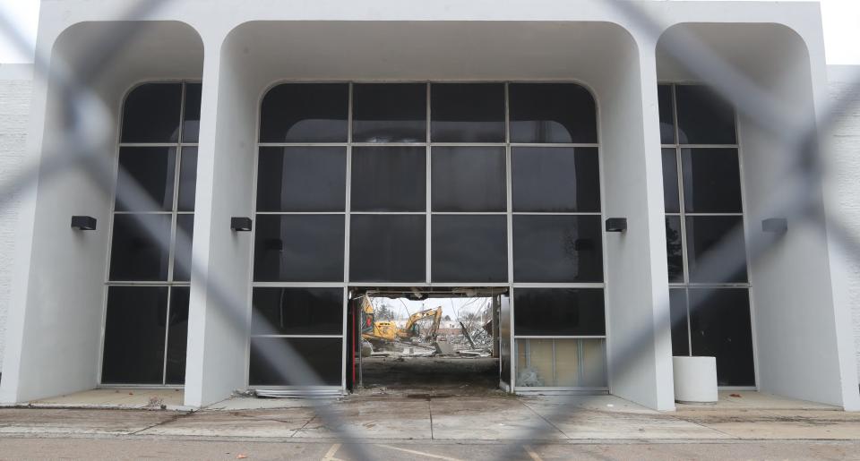 Workers from B&B Wrecking demolish the former Macy’s department store in the Stow-Kent Plaza on Monday.