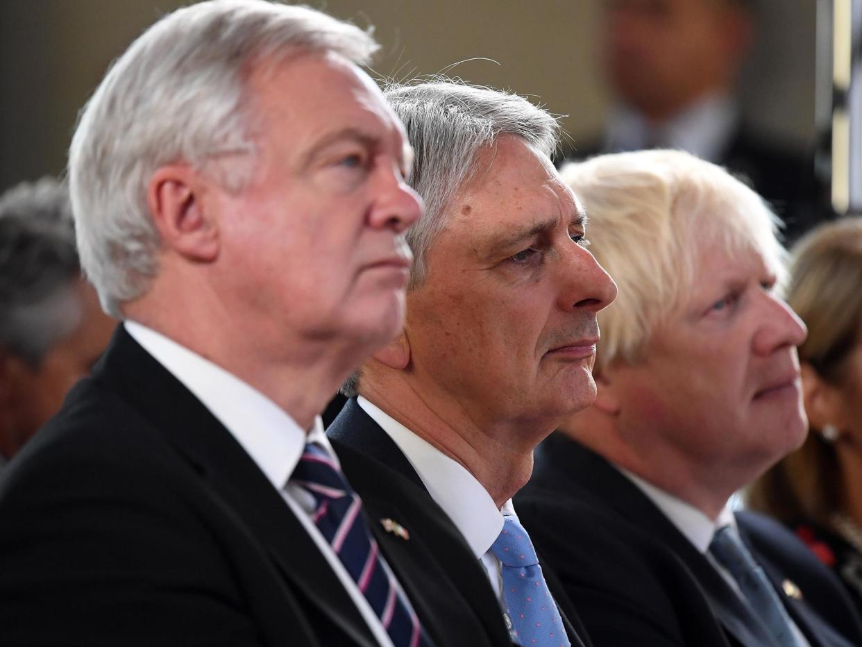 David Davis, Philip Hammond and Boris Johnson listen with intent to Theresa May's Brexit speech: Getty