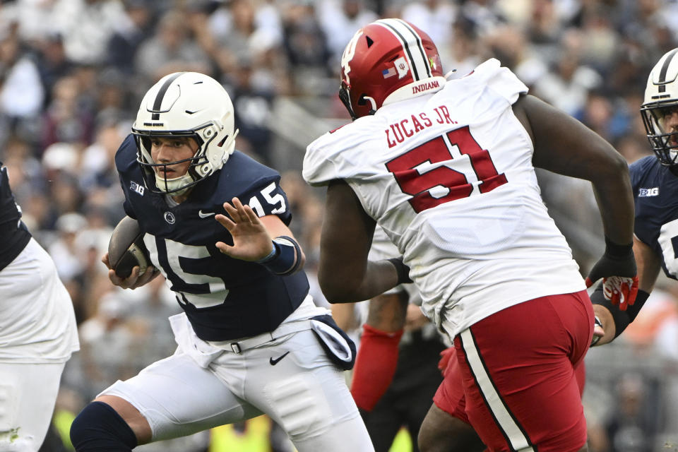 Penn State quarterback Drew Allar (15) looks to elude Indiana defensive lineman Patrick Lucas Jr. (51) during the first half of an NCAA college football game, Saturday, Oct. 28, 2023, in State College, Pa. (AP Photo/Barry Reeger)