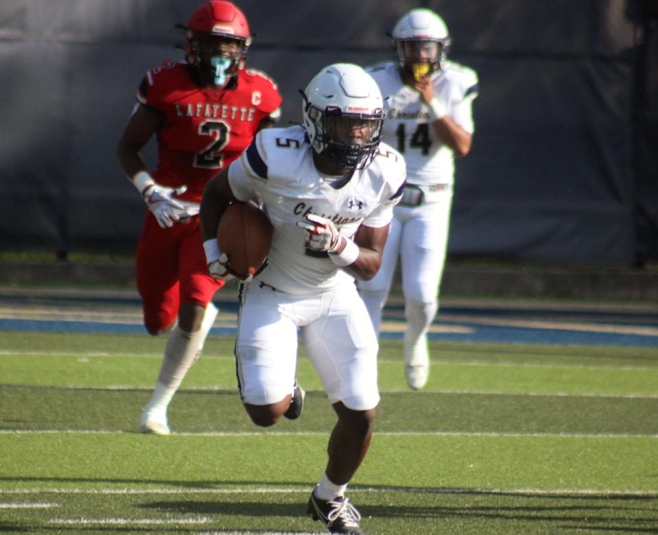 University Christian running back Alan Woods (5) breaks upfield for yardage against Mayo Lafayette during a high school spring football game.