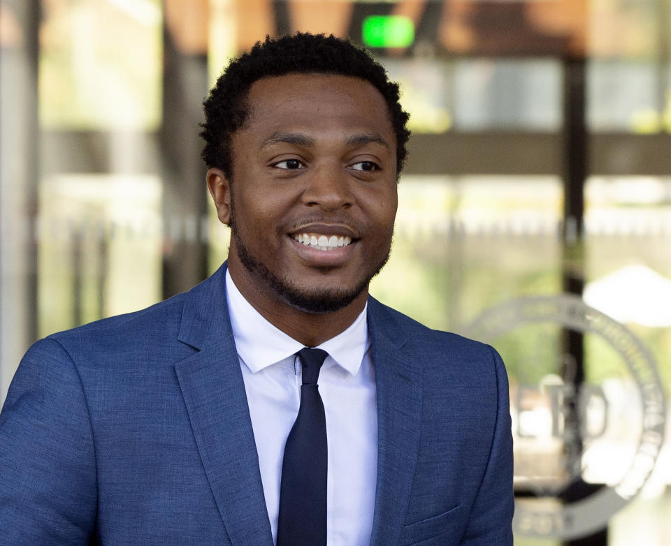 Rapper Marcus Gray smiles as he leaves the federal courthouse in Los Angeles Thursday, Aug. 1, 2019. Katy Perry, her collaborators and her record label must pay more than $2.78 million because the pop star's 2013 hit "Dark Horse" copied a Christian rap song, a jury decided Thursday. It was an underdog victory for rapper Gray, a relatively obscure artist once known as Flame whose 5-year-old lawsuit survived constant court challenges. (AP Photo/Damian Dovarganes)