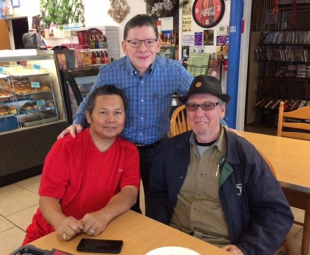 George Kim (left), owner of AM Donuts, and Paul Matta (center) meet with singer, songwriter and musician Joe Sonny West (right). West wrote the songs “Oh Boy” and “Rave On,” two of Buddy Holly’s biggest hits.