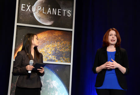 Space Telescope Science Institute astronomer Nikole Lewis (R) makes remarks as NASA Public Affairs Officer Felicia Chou listens, during a news conference to present new findings on exoplanets, planets that orbit stars other than Earth's sun, in Washington, U.S., February 22, 2017. REUTERS/Mike Theiler