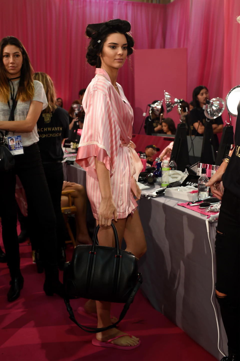 <p>Bet you never thought you’d see a Kardashian/Jenner wearing the flimsy sandals you wore in your dorm shower! Jenner fit right in with the VS Angels while getting ready for the 2015 Victoria’s Secret Fashion Sow, filming Tuesday. Wearing a stripy pink robe and her hair in curlers, the first-time strutter prepped for the massive televised annual event, which will air on CBS in December.</p>