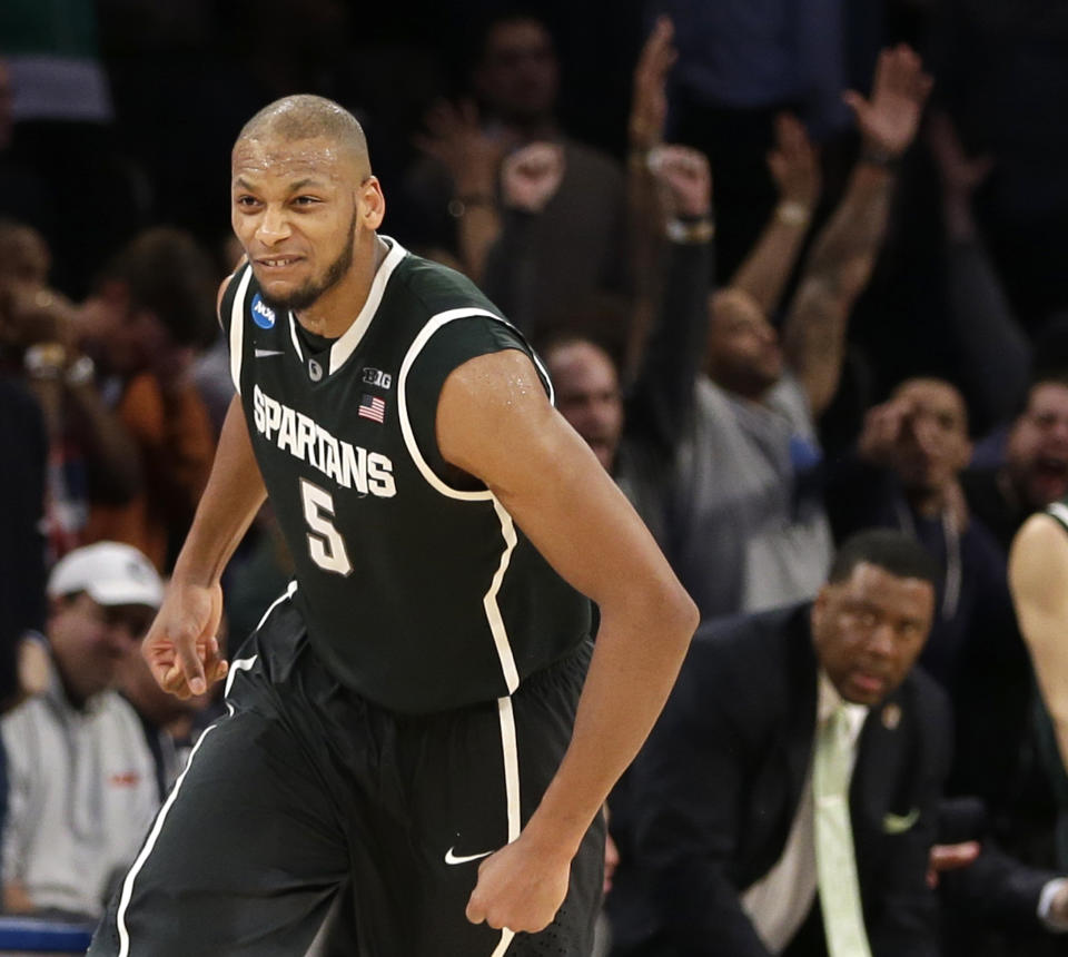 Michigan State's Adreian Payne celebrates after scoring in the second half of a regional semifinal against Virginia at the NCAA men's college basketball tournament, early Saturday, March 29, 2014, in New York. Michigan State won 61-59. (AP Photo/Seth Wenig)