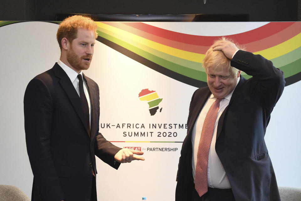 Britain's Prince Harry and Prime Minister Boris Johnson, right, at the UK Africa Investment Summit in London, Monday Jan. 20, 2020. Boris Johnson is hosting 54 African heads of state or government in London. The move comes as the U.K. prepares for post-Brexit dealings with the world. (Stefan Rousseau/Pool via AP)