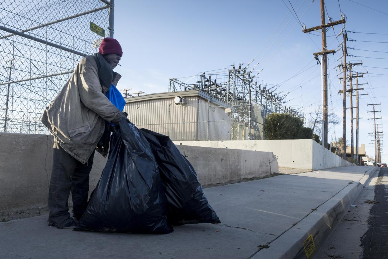 Casey prepares to carry his bag of cans to a recycling center after speaking to volunteers during the Point-in-Time count in Old Town Victorville in January 2019.