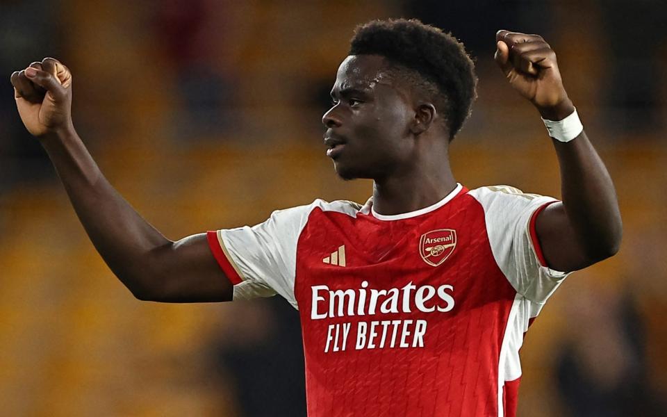 Bukayo Saka raises his fists in the air in celebration