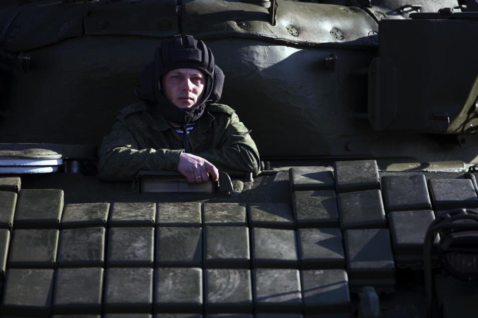 Russian solder sits in the tank T-72B at the Ostryakovo railway station not far from Simferopol, Crimea, Monday, March 31, 2014. Russian tanks T-72B will be stationed on former Ukrainian military bases. (AP Photo/Pavel Golovkin)