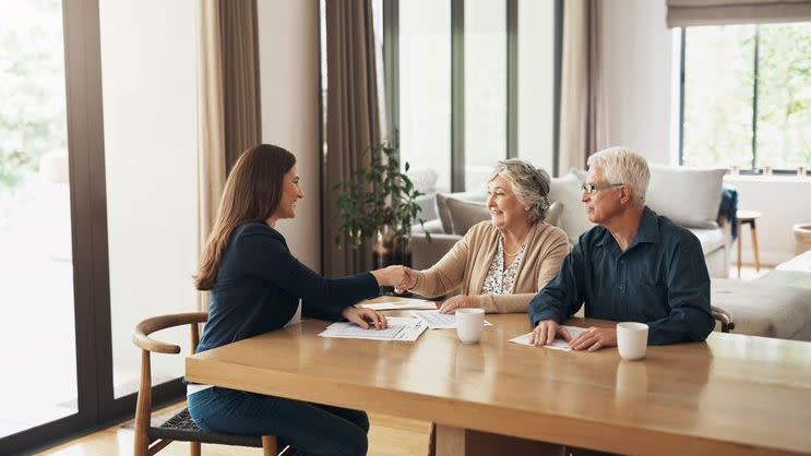 An insurance agent meets with a couple about annuity options. 