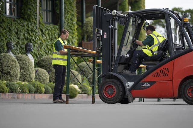 Maintenance staff lift barriers into place ahead of this year's tournament