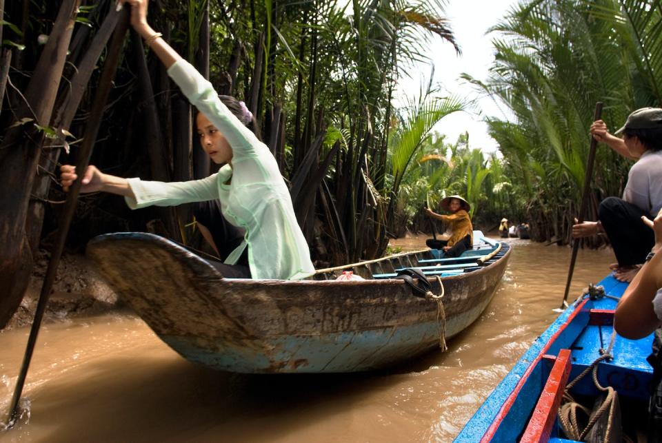 The Mekong Delta in Vietnam is essential to transportation, food and culture. <a href="https://www.gettyimages.com/detail/news-photo/woman-on-a-rowing-boat-on-mekong-river-near-my-tho-village-news-photo/849862626" rel="nofollow noopener" target="_blank" data-ylk="slk:Sergi Reboredo/VW PICS/Universal Images Group via Getty Images;elm:context_link;itc:0;sec:content-canvas" class="link ">Sergi Reboredo/VW PICS/Universal Images Group via Getty Images</a>
