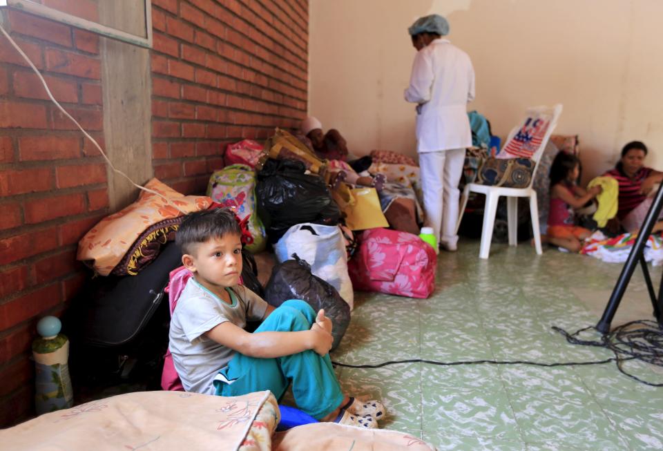 A Colombian boy deported from Venezuela sits in a temporary shelter in Villa del Rosario village, Colombia
