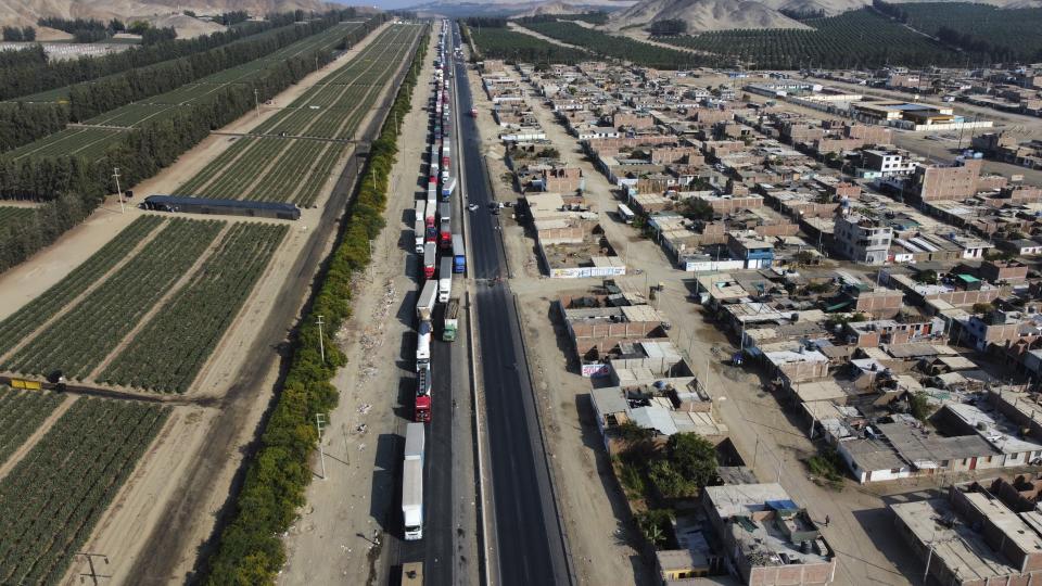 Truckers are backed up on the Pan-American North highway as supporters of ousted Peruvian President Pedro Castillo block it to protest his detention in Viru, Peru, Thursday, Dec.15, 2022. Peru's new government declared a 30-day national emergency on Wednesday amid violent protests following Castillo's ouster, suspending the rights of "personal security and freedom" across the Andean nation. (AP Photo/Hugo Curotto)