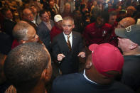 FILE - In this Sunday, Dec. 8, 2019, file photo, new Florida State NCAA college football head coach Mike Norvell talks to football staffers after a news conference, in Tallahassee, Fla. Norvell is taking over a Seminoles program that has struggled while he was helping to build Memphis into a Group of Five power. Florida State got in three practices before the new coronavirus outbreak shut down college sports and upended nearly everything else. (AP Photo/Phil Sears, File)
