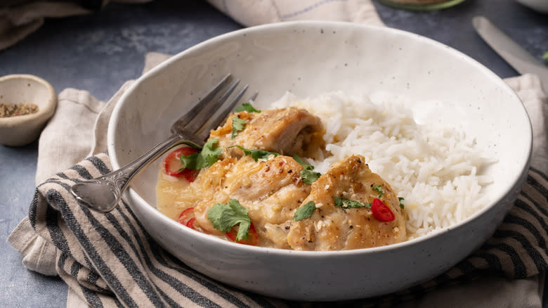 coconut lime chicken thighs in bowl with rice