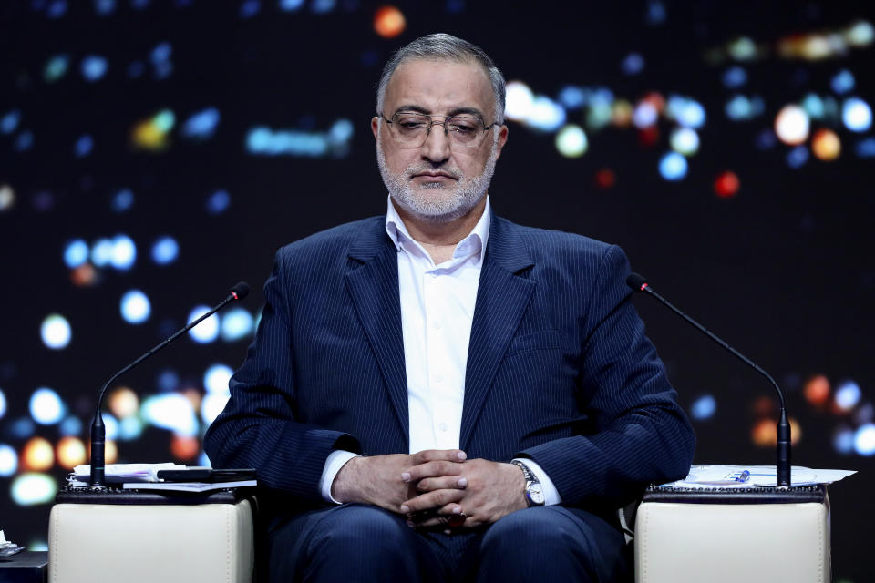 In this picture made available by Iranian state-run TV, IRIB, presidential candidate for June 28, election Alireza Zakani, who is Tehran Mayor, attends a debate of the candidates at the TV studio in Tehran, Iran, Monday, June 17, 2024. (Morteza Fakhri Nezhad/IRIB via AP)