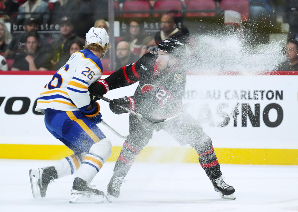 Ottawa Senators defenceman Erik Brannstrom (26) pushes Buffalo Sabres defenseman Rasmus Dahlin (26) during the second period of an NHL hockey game Tuesday, Oct. 24. 2023, in Ottawa, Ontario. (Sean Kilpatrick/The Canadian Press via AP)