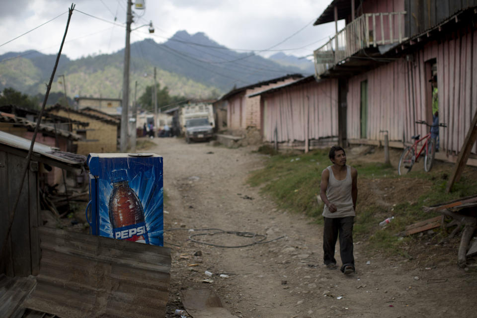 In this Feb. 11, 2014 photo, a man walks down a dusty street in Cochoapa El Grande, Mexico. The farming town of 2,600 people is located high in the pine-covered mountains of Guerrero state in southern Mexico. (AP Photo/Dario Lopez-Mills)