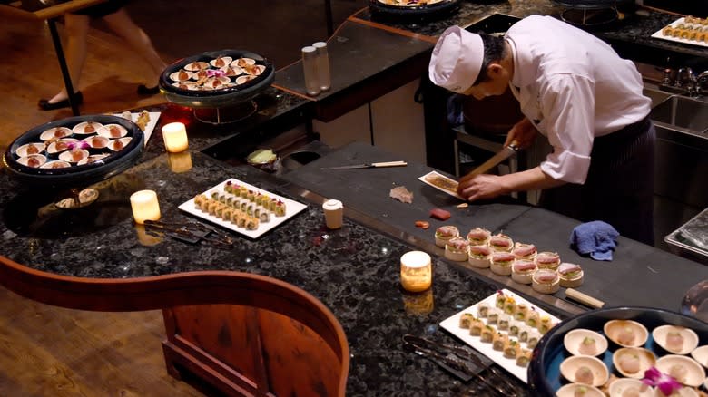 Chef preparing assortment of sushi
