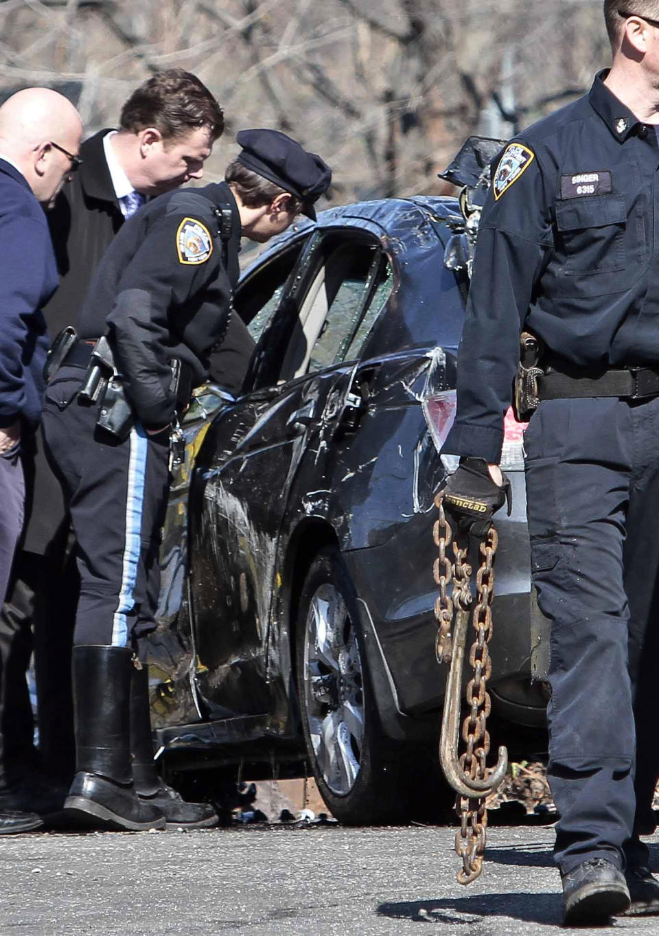 Police investigate a 2009 Honda Accord recovered from the Steinway Creek on Saturday April 5, 2014 in New York. The driver of the car drove off a dead-end street in a desolate industrial area, flipped over a wooden curb into the East River inlet killing four passengers. The driver escaped serious injury and told officers at the scene in the Astoria section of Queens that the four were trapped in the submerged car. Fire department divers pulled the four victims from the car. Police identified them as 21-year-old Darius Fletcher, 19-year-old Jada Monique Butts, 19-year-old Crystal Gravely and 20-year-old Jaleel Furtado. They were pronounced dead at hospitals. (AP Photo/Bebeto Matthews)