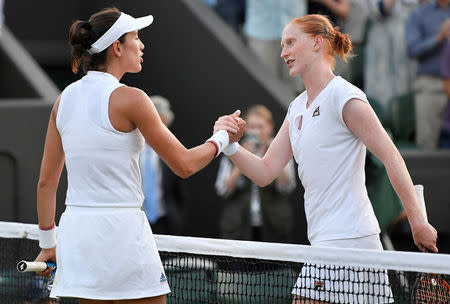 Tennis - Wimbledon - All England Lawn Tennis and Croquet Club, London, Britain - July 5, 2018. Belgium's Alison Van Uytvanck shakes hands with Spain's Garbine Muguruza after winning her second round match. REUTERS/Toby Melville