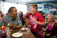 <p>“‘Anyone want to try a piece of my strawberry pie,’ the President asked those at adjacent tables during a stop for lunch at Kozy Corners restaurant in Oak Harbor, Ohio on July 5, 2012. A young boy said yes and came over for a big bite of pie.” (Pete Souza/The White House) </p>