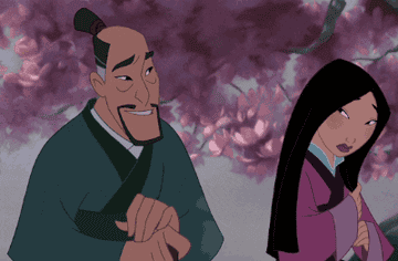 Fa Zhou puts a flower pick in Mulan's hair