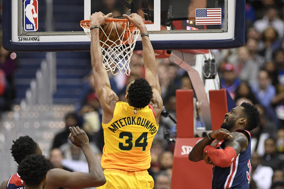 Milwaukee Bucks forward Giannis Antetokounmpo (34) dunks against Washington Wizards forward Jeff Green, right, during the first half of an NBA basketball game, Saturday, Feb. 2, 2019, in Washington. Green was called for a foul on the play. (AP Photo/Nick Wass)
