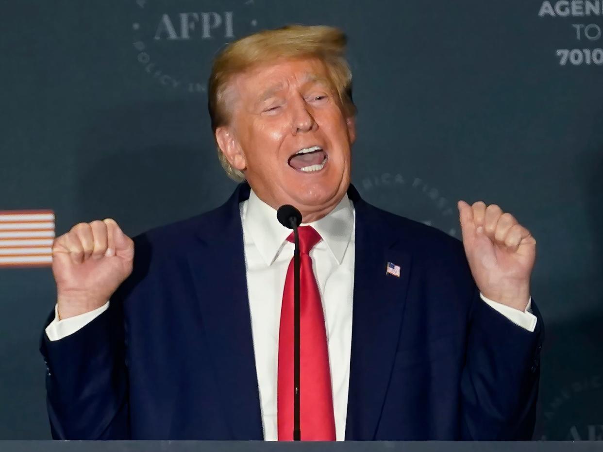 Former President Donald Trump talks about lifting weights as he speaks at an America First Policy Institute agenda summit at the Marriott Marquis in Washington, Tuesday, July 26, 2022.