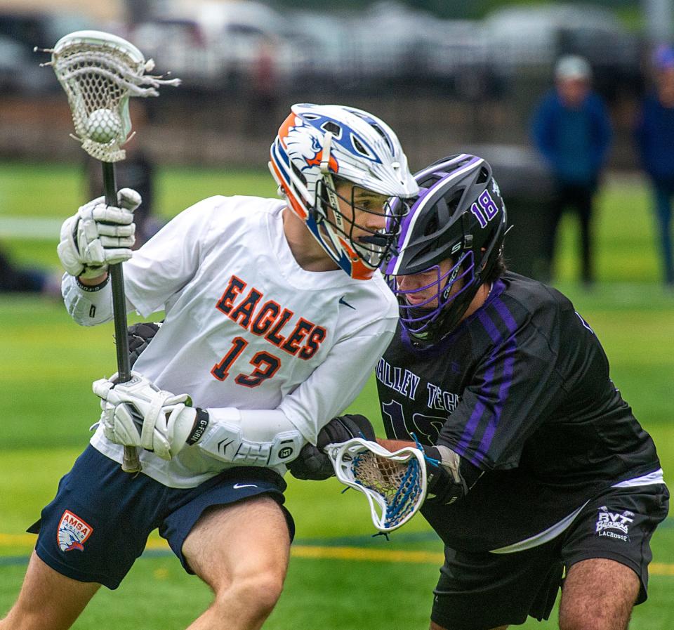 Advanced Math & Science Academy Charter School  (AMSA) lacrosse junior Tavin Hirsh, of Marlborough, defended by  Blackstone Valley Technical School (BVT) senior Rudy Patete in a Round of 32 playoff game, June 5, 2023, at the Forekicks Sports Complex in Marlborough.