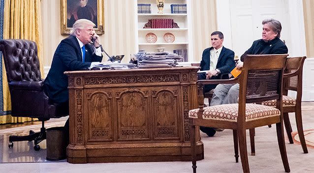 Breitbart founder and  Trump adviser Steve Bannon, right, and National Security Advisor Michael Flynn watch as Donald Trump calls Malcolm Turnbull via telephone. Photo: AAP