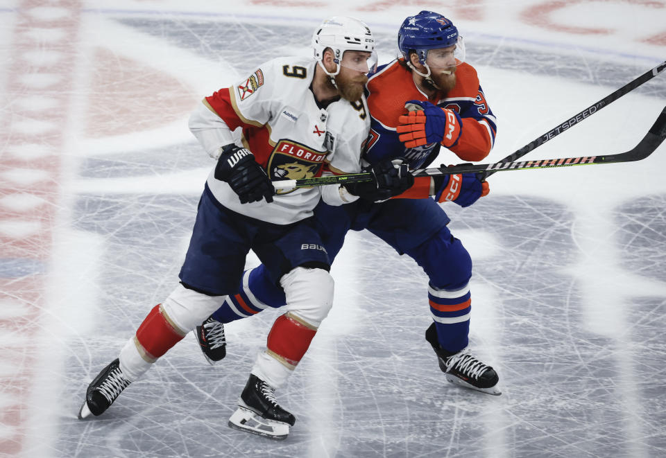 Florida Panthers' Sam Bennett (9) checks Edmonton Oilers' Connor McDavid (97) during the second period of Game 6 of the NHL hockey Stanley Cup Final, Friday, June 21, 2024, in Edmonton, Alberta. (Jeff McIntosh/The Canadian Press via AP)