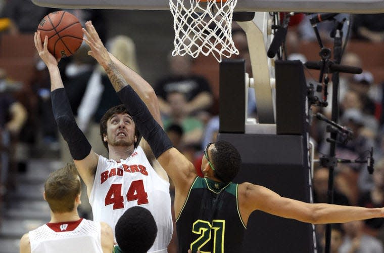 Wisconsin forward Frank Kaminsky (44) shoots over Baylor center Isaiah Austin (21) during an NCAA men's college basketball tournament regional semifinal, Thursday, March 27, 2014, in Anaheim, Calif. (AP Photo/Mark J. Terrill)