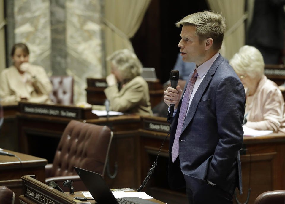 In this Jan. 30, 2019 photo, Sen. Jamie Pedersen, D-Seattle, speaks on the Senate floor at the Capitol in Olympia, Wash. Pedersen is the primary sponsor of a bill that has Washington poised to become the first state in the U.S. to allow a human burial alternative known as "natural organic reduction," an accelerated process of decomposition that turns a body into soil in a matter of weeks. The bill legalizing the process, sometimes referred to as human composting, has passed key votes in both the Senate and the House and awaits a final vote in the Senate. (AP Photo/Ted S. Warren)