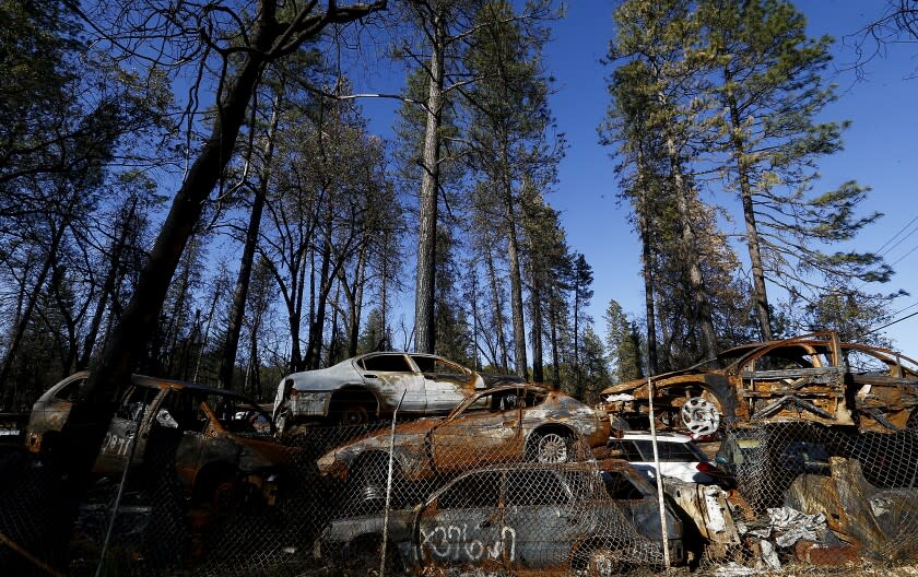PARADISE, CALIF. - OCT. 31, 2019. Charred cars from the Camp fire are stacked in a lot along Skyway Road in Paradise, a community that was alsmost completely destroyed a year go. (Luis Sinco/Los Angeles Times)